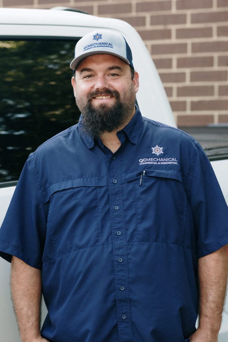 Man in a blue work shirt and matching cap with 