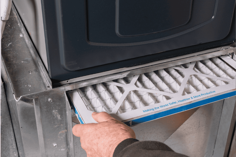 Technician replacing furnace filter – can I run my furnace without a filter for a day