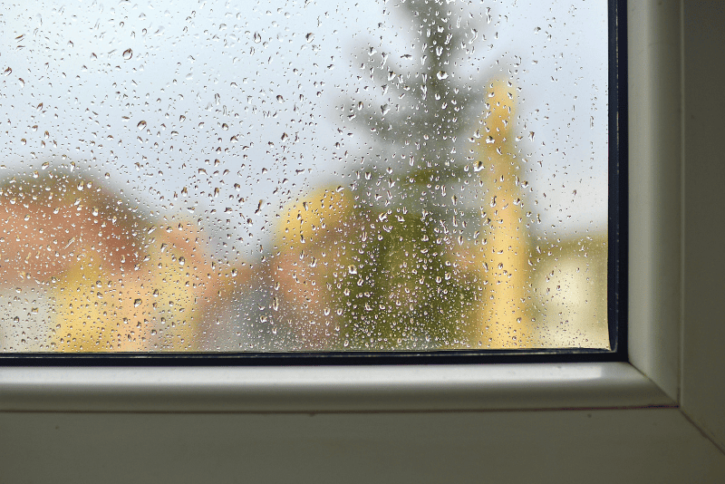Foggy window with moisture showing why my house is so humid with AC running